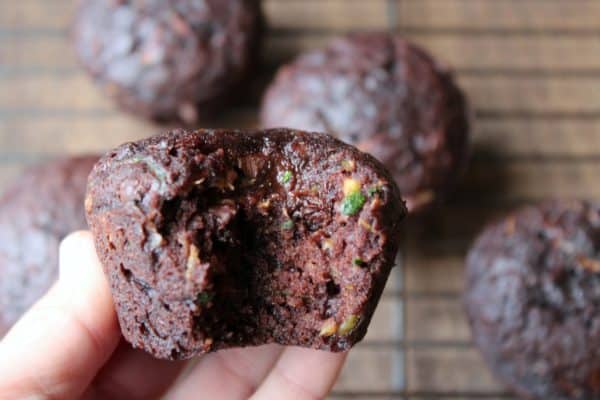 chocolate zucchini muffins with a bite taken from it