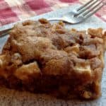 Slice of apple cake with a fork on a gray plate