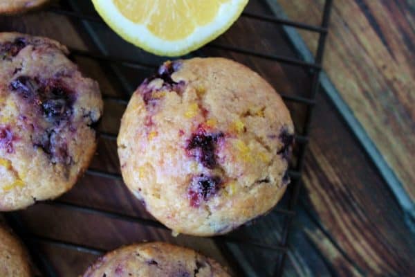 Tops of lemon blueberry muffins and a cut lemon