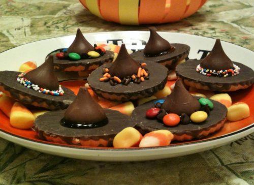 Halloween decorative plate piled with chocolate withes' hats and candy corn.