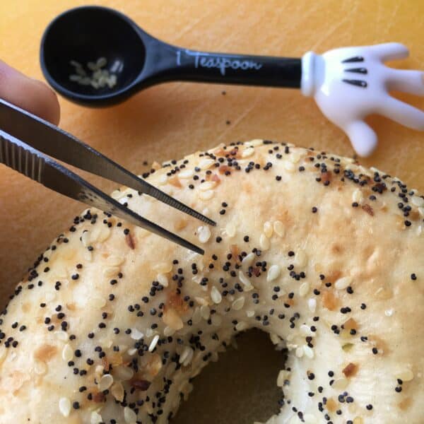 picking sesame seeds off an everything bagel